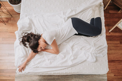 8-inch Gel Memory Foam Mattress on white bedding with a woman resting on Tampa Home & Garden Store