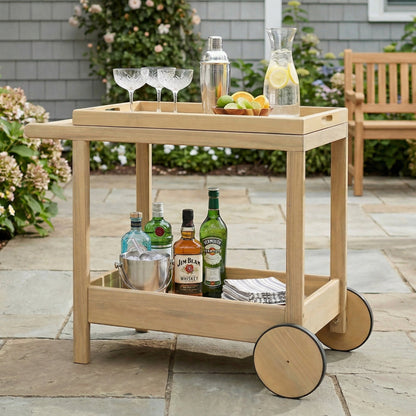 Saratoga Outdoor Rolling Bar Cart in natural wood finish with wheels, liquor bottles and glassware on Tampa Home & Garden Store