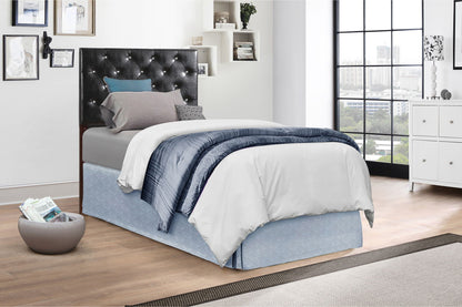 Upholstered headboard in black tufted faux leather with crystal buttons in a modern bedroom on Tampa Home & Garden Store