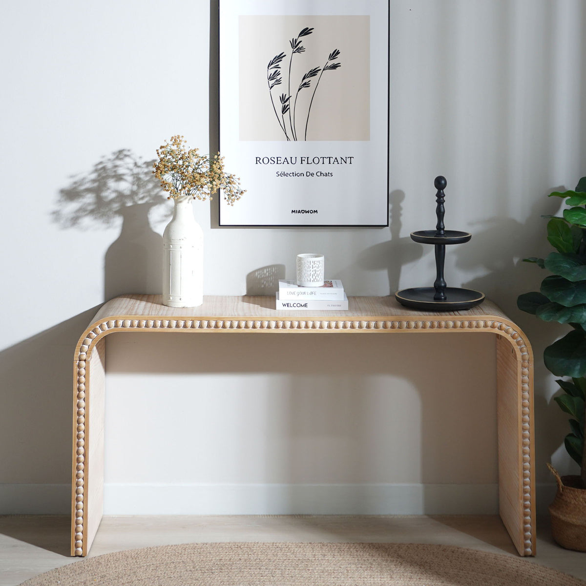 Waterfall Console Table in light brown wood with bead trim, paired with white vase and art on wall on Tampa Home & Garden Store