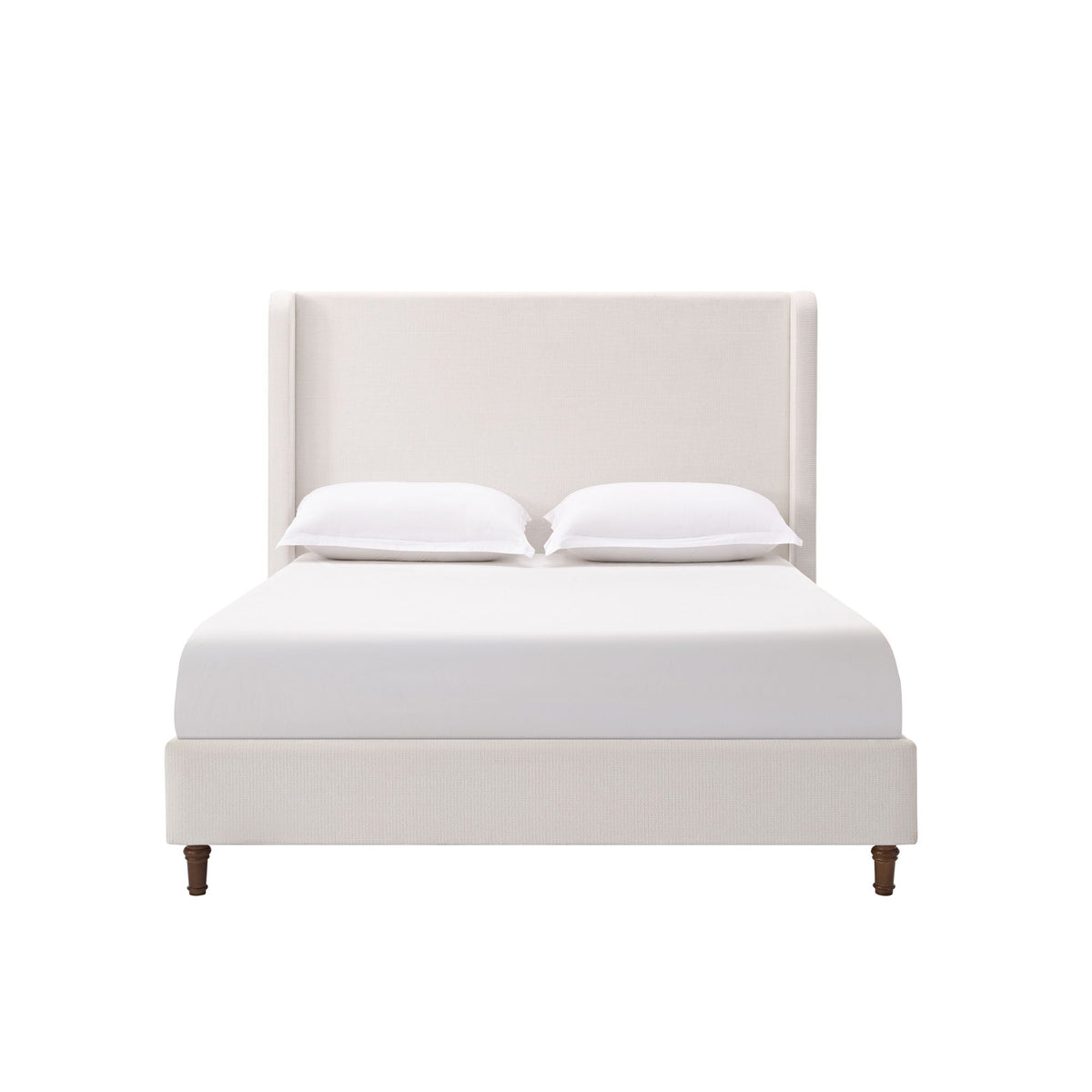 Harper tall upholstered bed with beige fabric headboard, white sheets and two pillows on Tampa Home & Garden Store