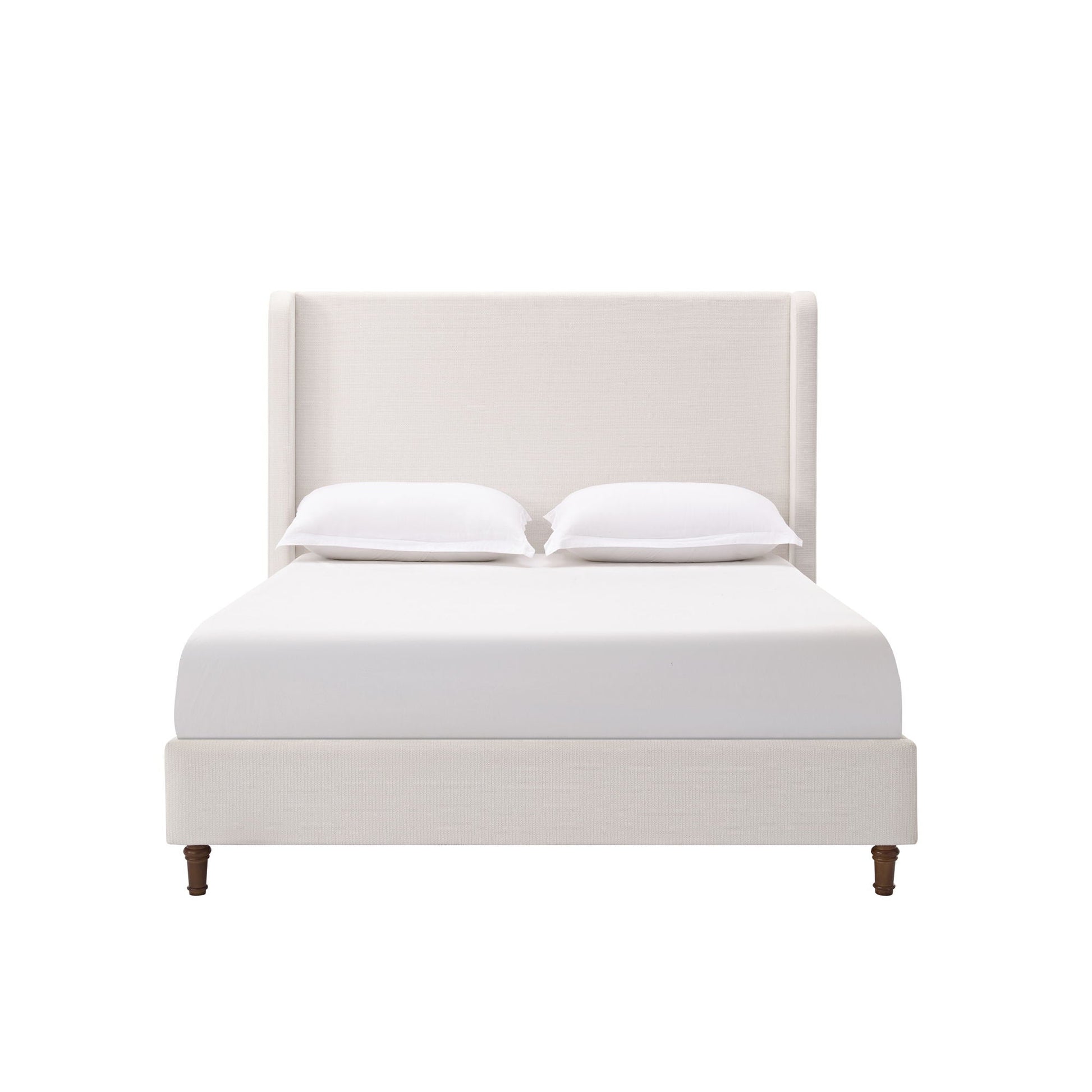 Harper tall upholstered bed with beige fabric headboard, white sheets and two pillows on Tampa Home & Garden Store