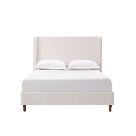 Harper tall upholstered bed with beige fabric headboard, white sheets and two pillows on Tampa Home & Garden Store