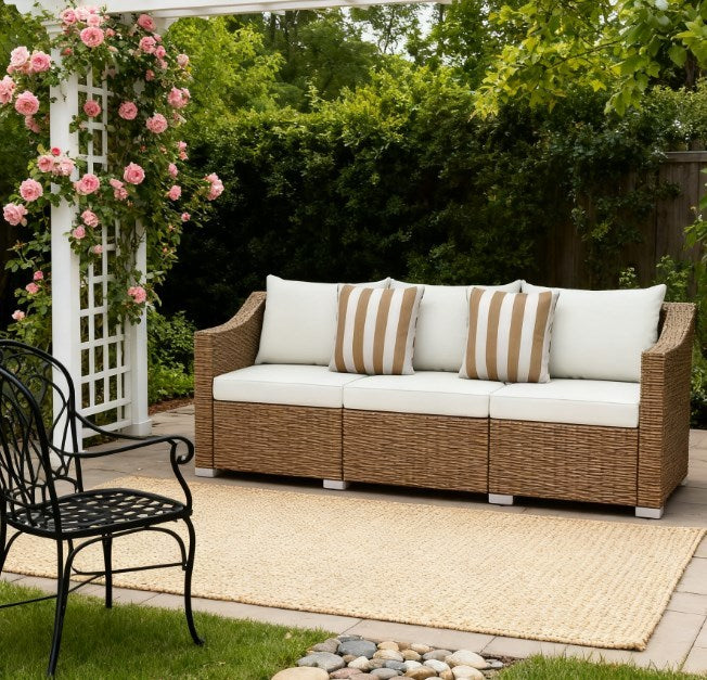 HouseOfZazla outdoor rattan sofa set with beige cushions and striped pillows on a sunny patio on Tampa Home & Garden Store
