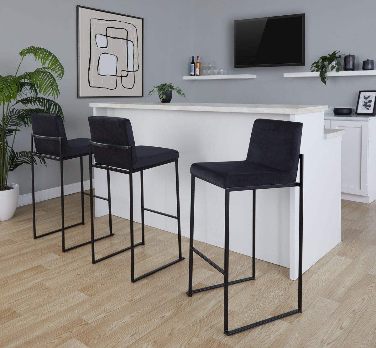 Set of 4 high-back black upholstered barstools with steel frames at a white marble counter on Tampa Home & Garden Store