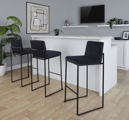 Set of 4 high-back black upholstered barstools with steel frames at a white marble counter on Tampa Home & Garden Store