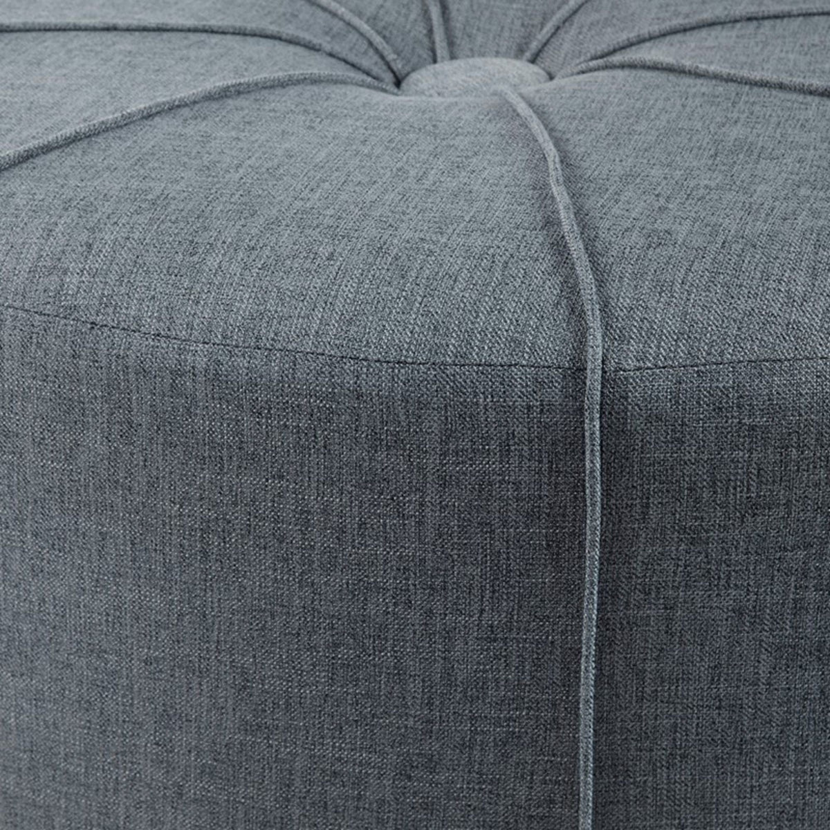 Large blue upholstered cocktail ottoman with a centered button tuft on Tampa Home & Garden Store