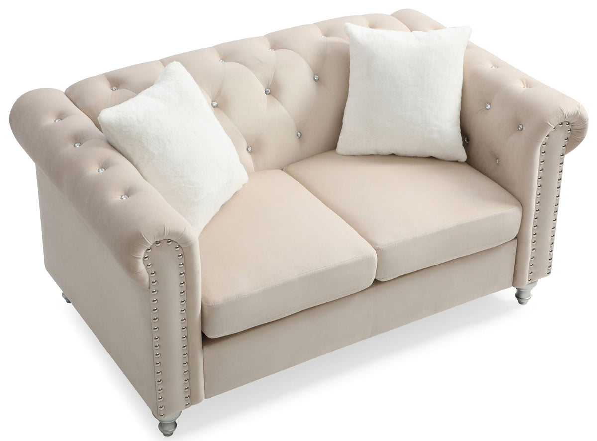 Contemporary loveseat beige faux leather with jeweled tufting and studded arms, 2 white pillows on Tampa Home & Garden Store
