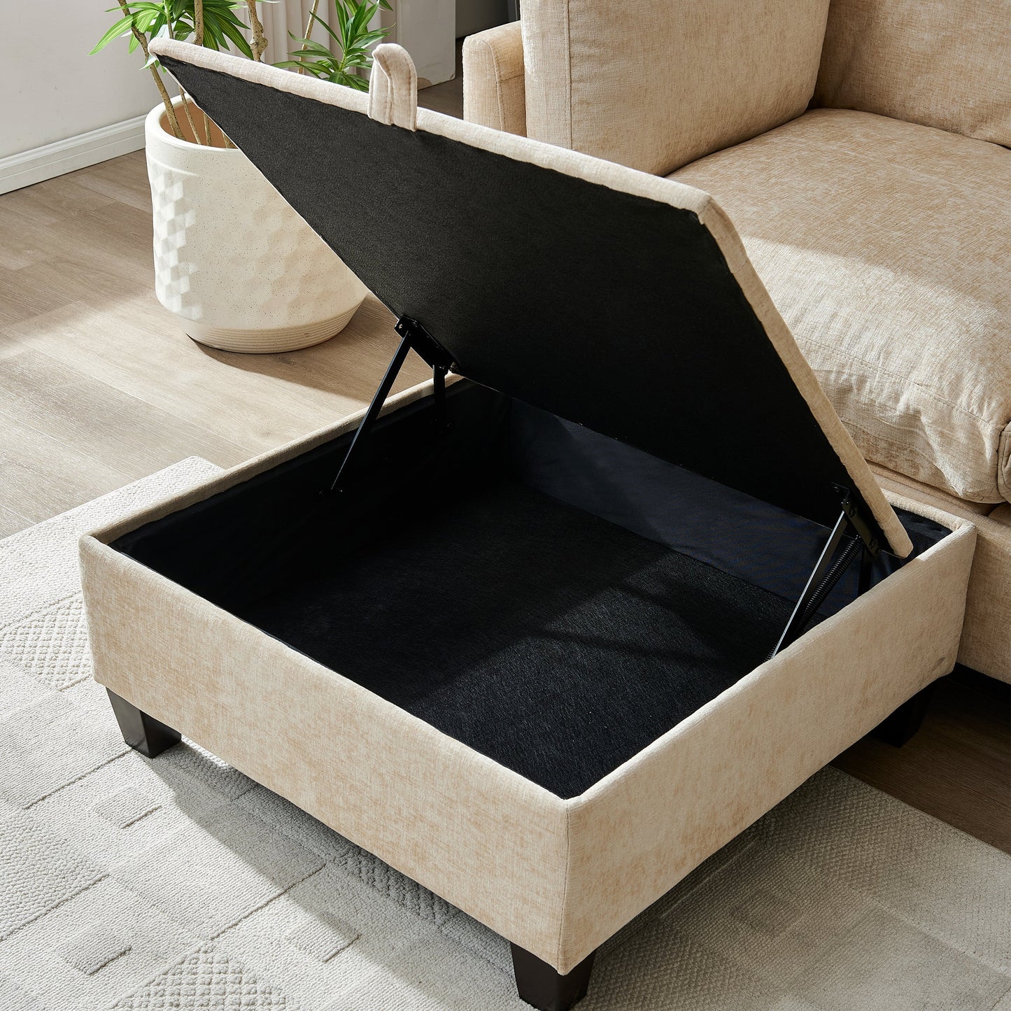 96.5 inch L-shaped sectional sofa with ottoman in tan beige fabric, exposed black base on Tampa Home & Garden Store