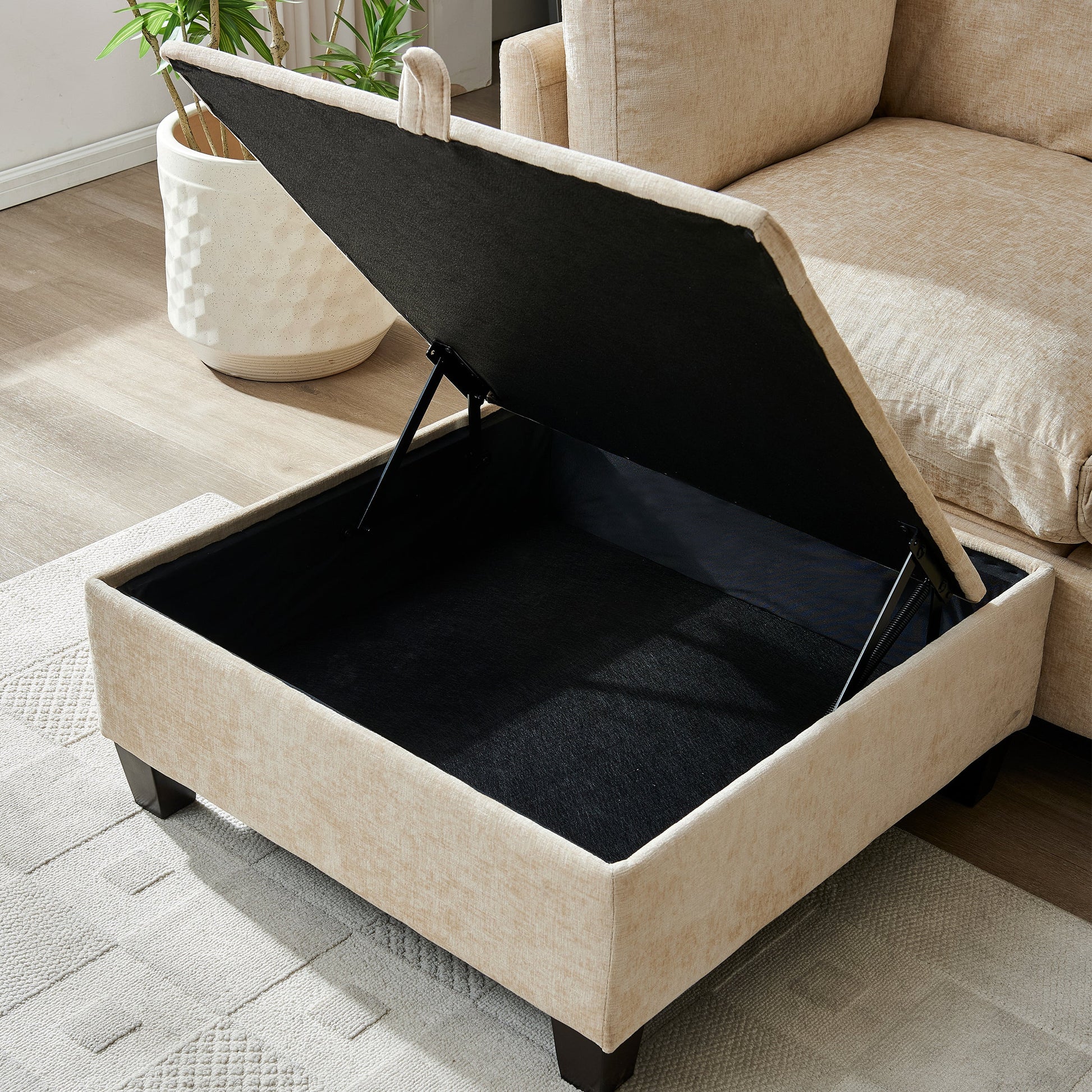 96.5 inch L-shaped sectional sofa with ottoman in tan beige fabric, exposed black base on Tampa Home & Garden Store