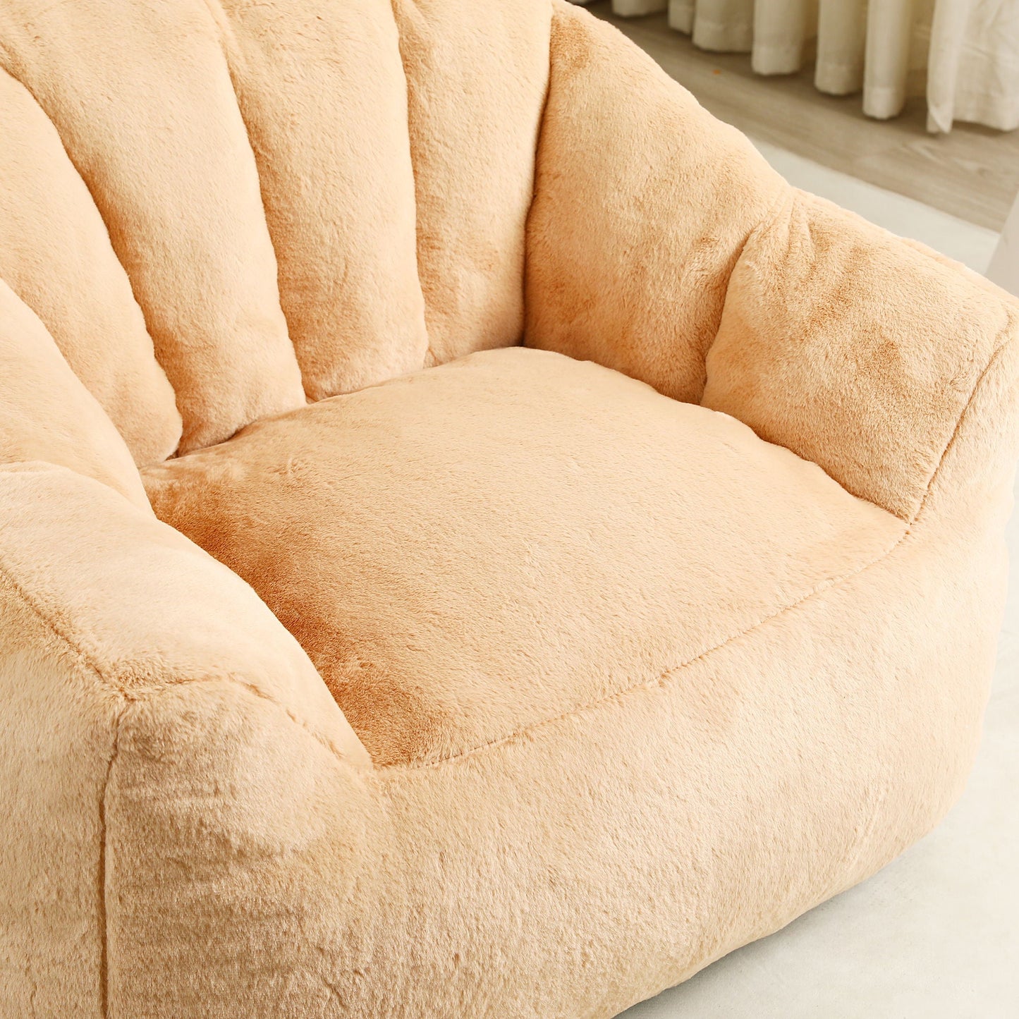 Beanbag sofa chair with armrests in soft beige plush fabric, close-up view on Tampa Home & Garden Store