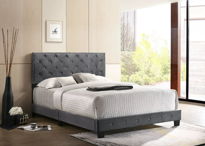 Luxurious upholstered bed with gray tufted headboard and nailhead trim in a modern bedroom on Tampa Home & Garden Store