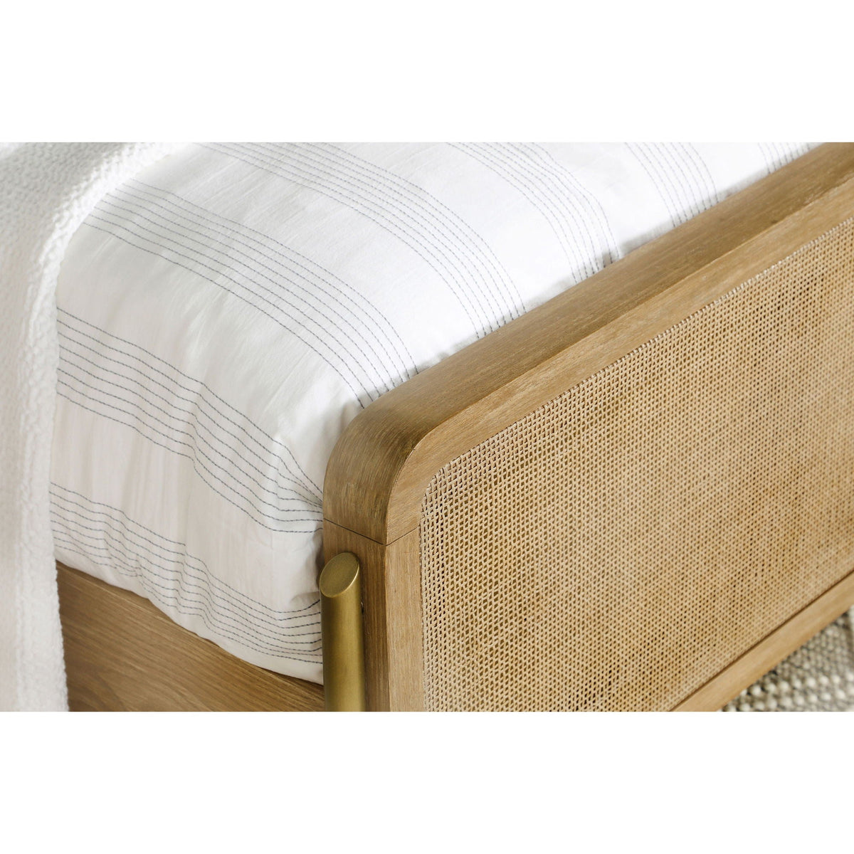 Stevie Panel Bed in natural wood with woven cane sides and white striped bedding on Tampa Home & Garden Store