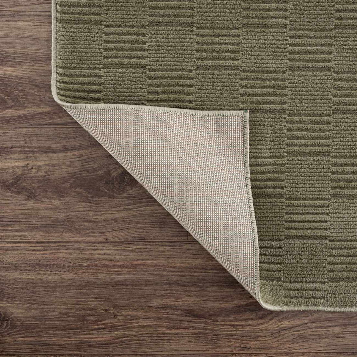 Kazuma green washable area rug with beige backing on Tampa Home & Garden Store