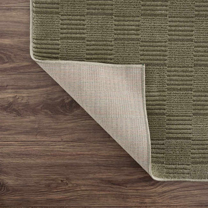 Kazuma green washable area rug with beige backing on Tampa Home & Garden Store