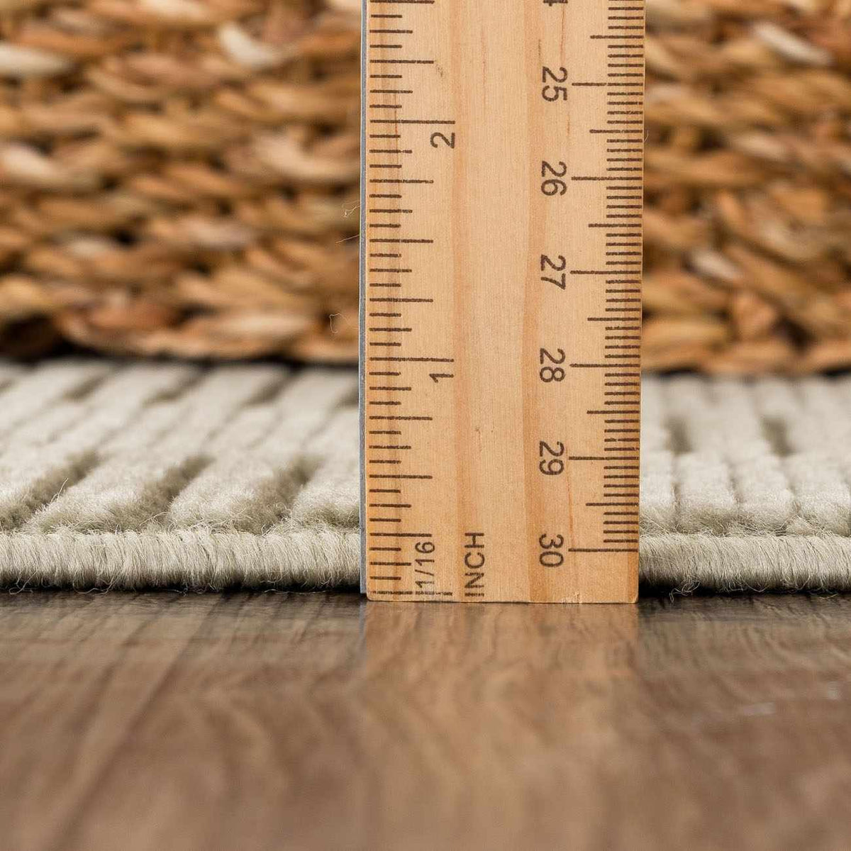 Kazuma Green Washable Area Rug beige low-pile texture on wood floor with inch ruler for scale on Tampa Home and Garden Store