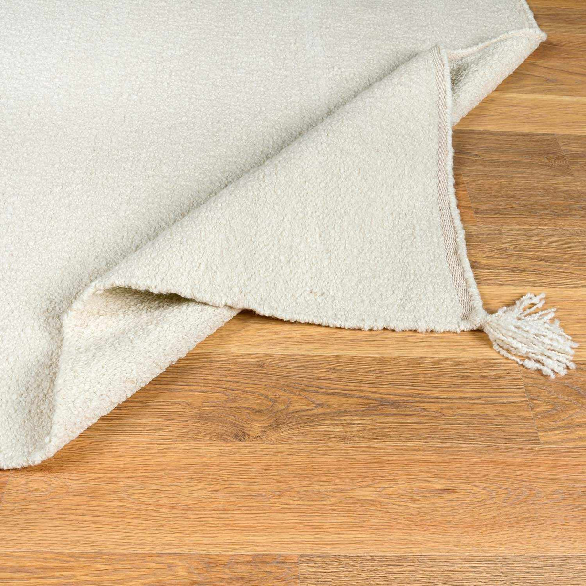 Niabi Area Rug cream plush shag with tassel fringe on wood floor on Tampa Home & Garden Store