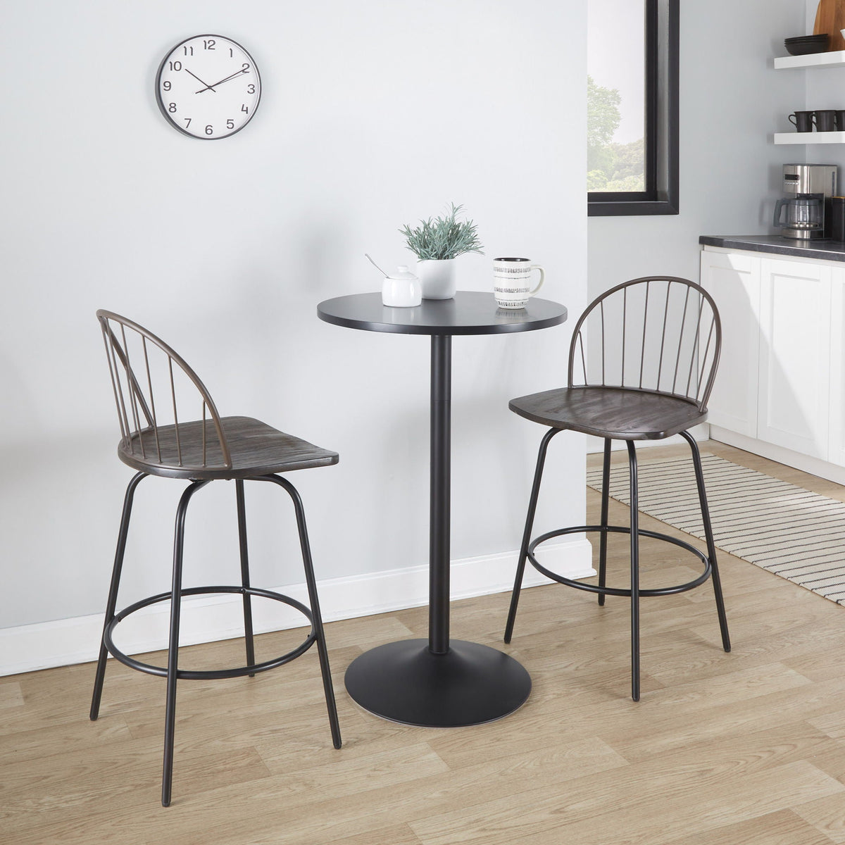 Farmhouse 3 counter stools with swivel dark brown seats and round footrests around a black table on Tampa Home & Garden Store