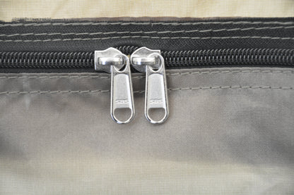 Oxford Bell Tent zipper pulls close-up, two SBS metal sliders on gray tent fabric on Tampa Home & Garden Store