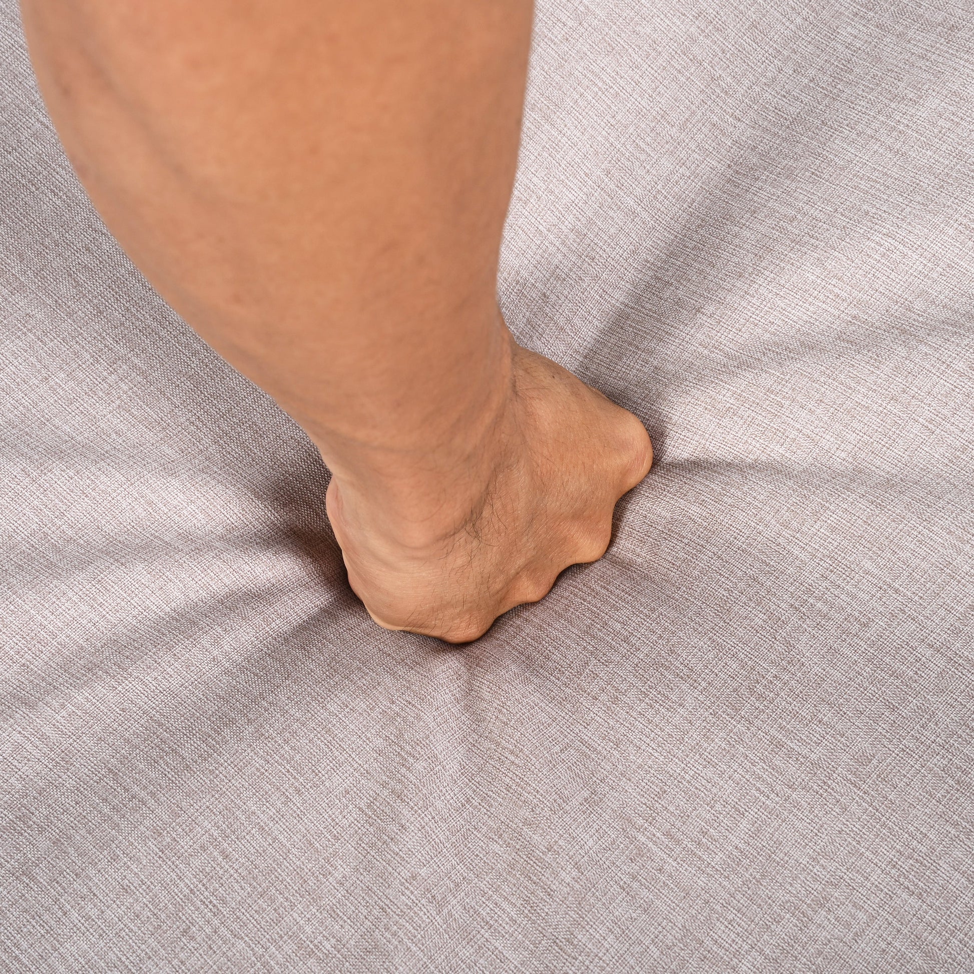 Outdoor Chaise Lounge Chair close-up of a tan leg resting on beige textured fabric surface on Tampa Home & Garden Store