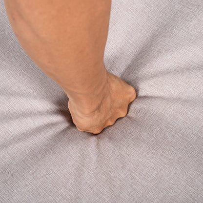 Outdoor Chaise Lounge Chair close-up of a tan leg resting on beige textured fabric surface on Tampa Home & Garden Store