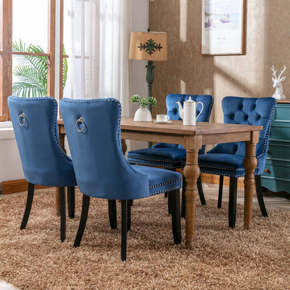 Tufted velvet dining chair set in blue with nailhead trim and ring-pull backs around a table on Tampa Home & Garden Store