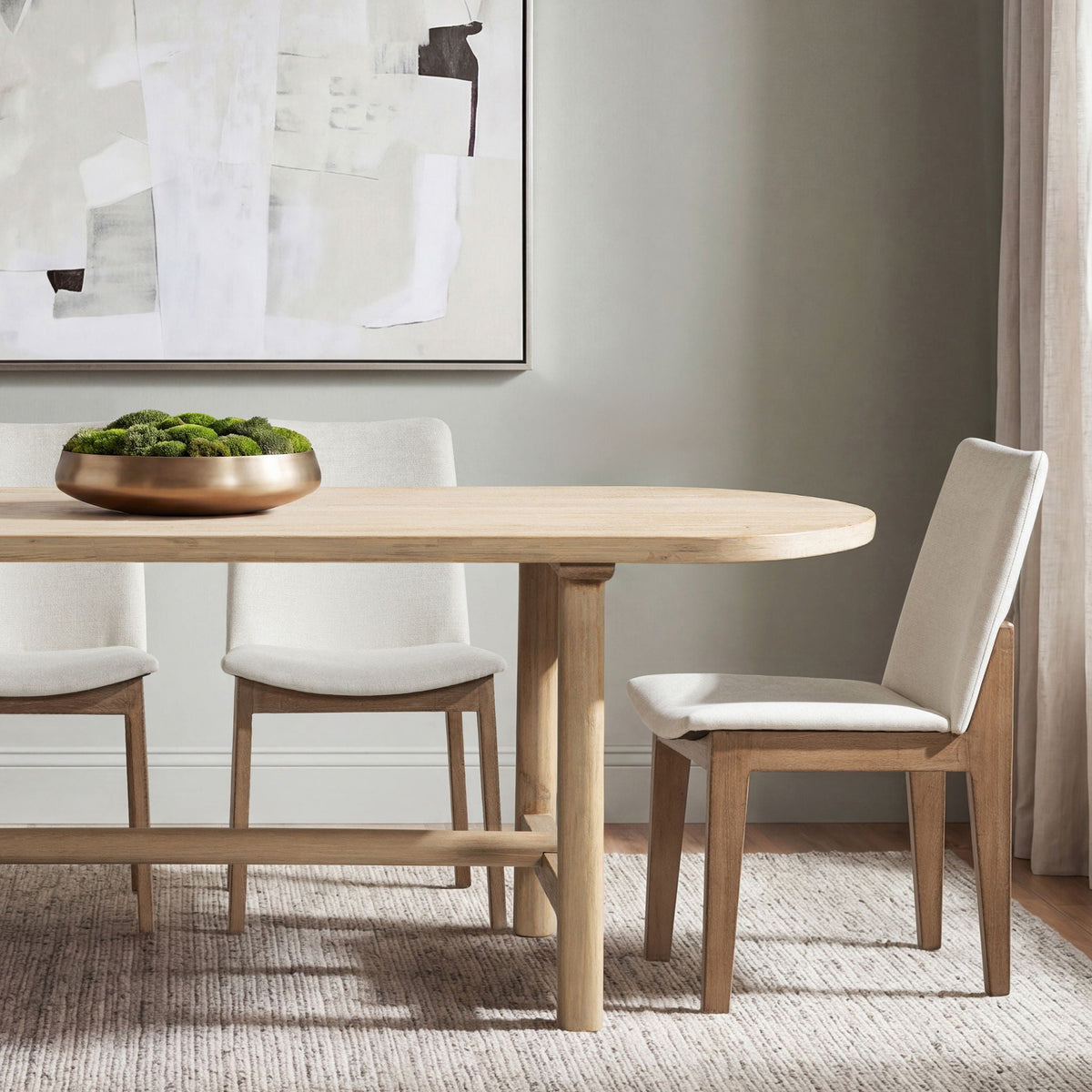 8-seat oval dining table in natural reclaimed pine with 4 beige upholstered chairs on Tampa Home & Garden Store
