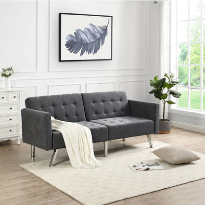Futon sofa bed with armrests in gray tufted fabric and metal legs in a bright living room on Tampa Home & Garden Store