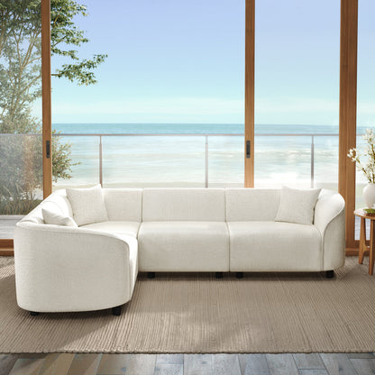 104-inch L-shaped curved beige sectional sofa with plush cushions in a seaside living room on Tampa Home & Garden Store