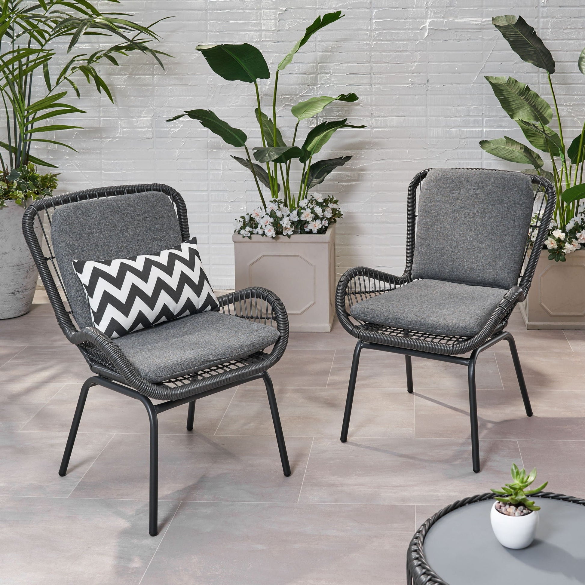 Outdoor wicker club chairs with grey cushions set of 2, left chair with a zigzag pillow on Tampa Home & Garden Store