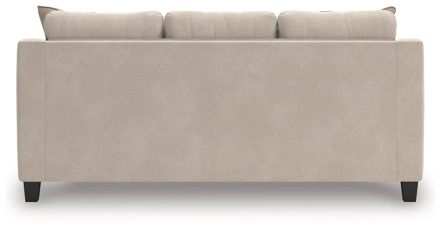 Willarae stationary sofa back view in beige fabric with black tapered legs on Tampa Home & Garden Store