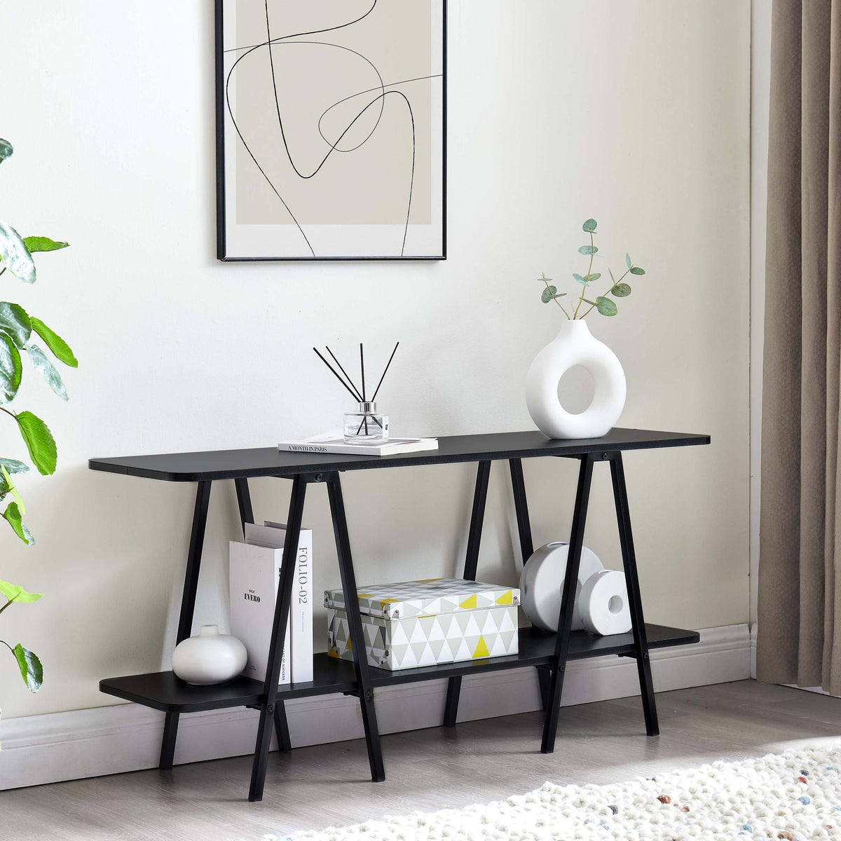 Modern console table with carbon steel black legs, two-tier frame, top with white vases on Tampa Home & Garden Store