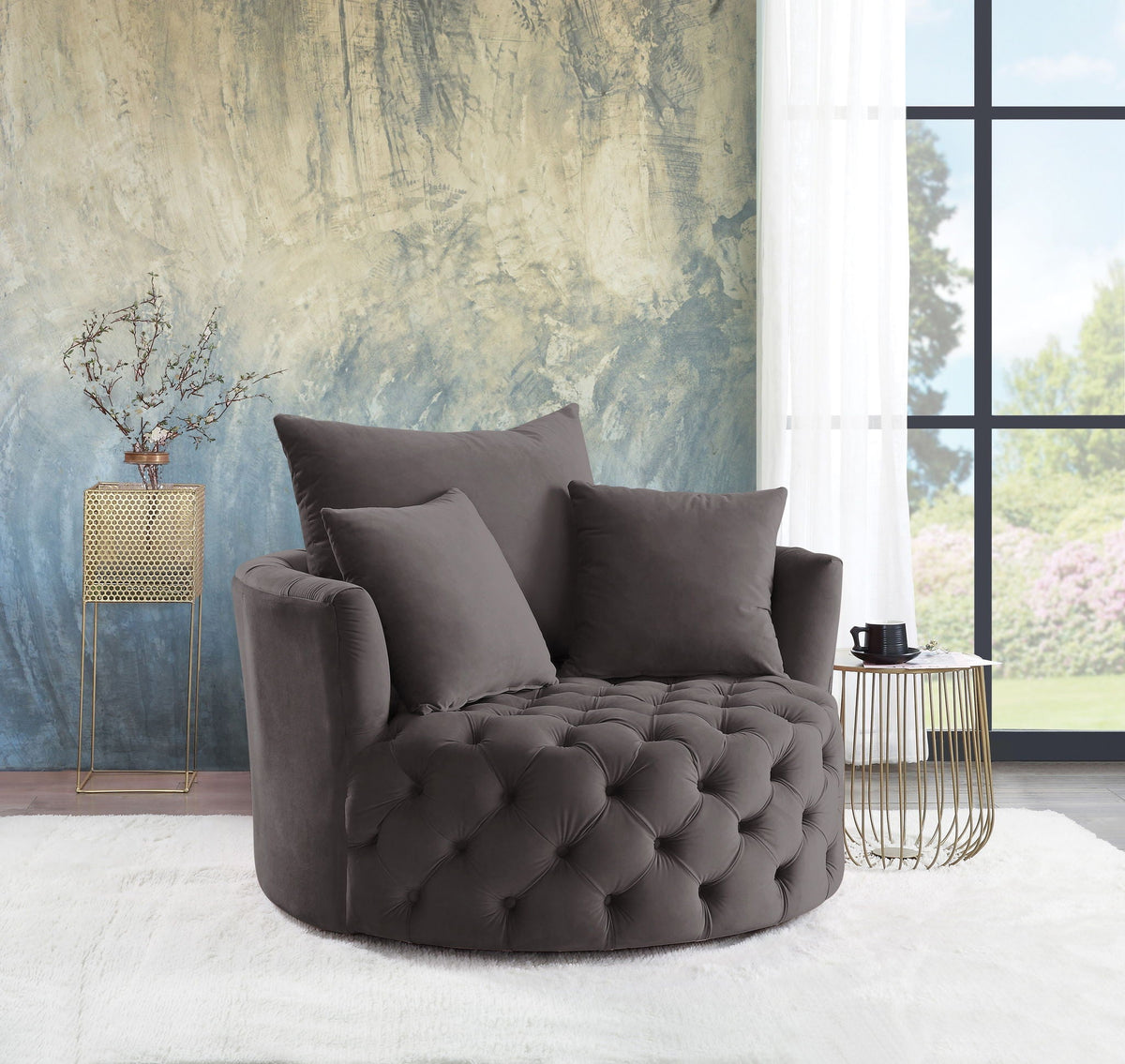 Velvet swivel accent chair in dark gray with button tufting in a living room setting on Tampa Home & Garden Store