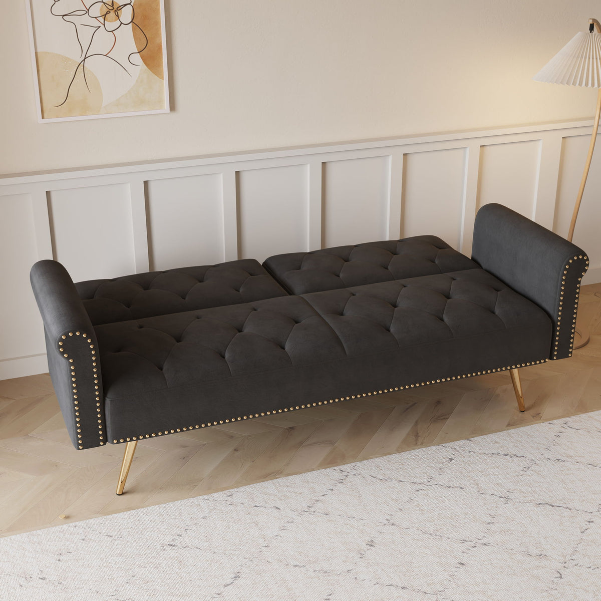 Velvet futon sofa bed with nail head trim in dark gray, tufted upholstery and slender gold legs on Tampa Home & Garden Store