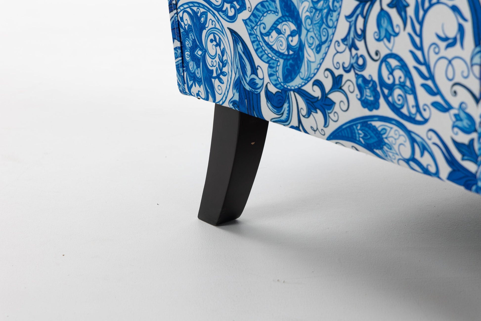 Accent chair upholstered in blue and white porcelain print linen fabric with a black wooden leg on Tampa Home & Garden Store