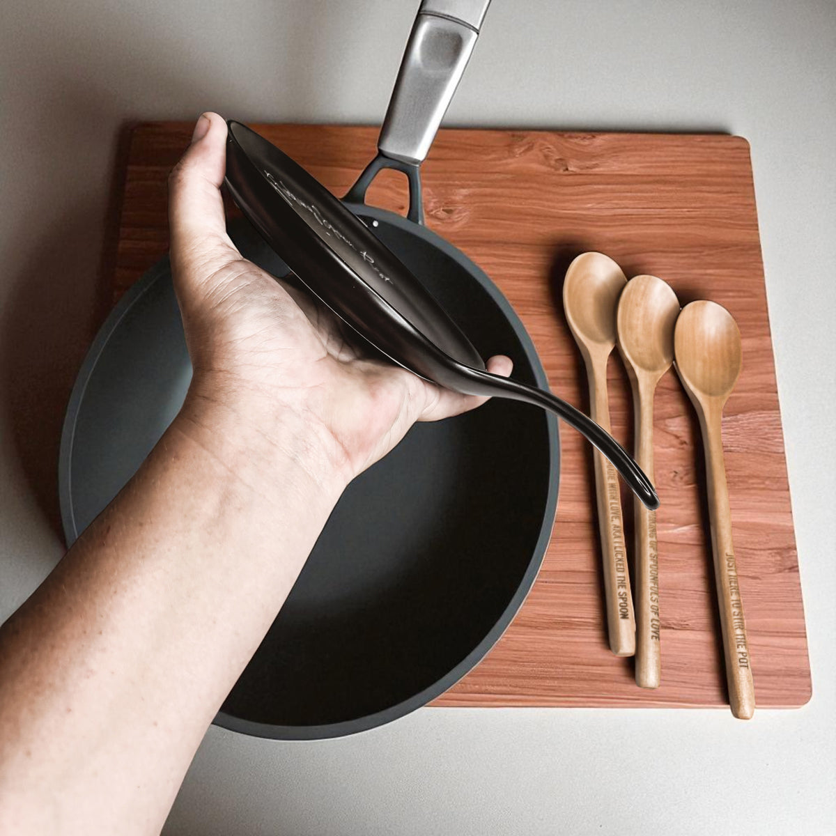 Gia Roma Lick the Spoon & Cook black spoon rest with four wooden spoons on cutting board on Tampa Home & Garden Store