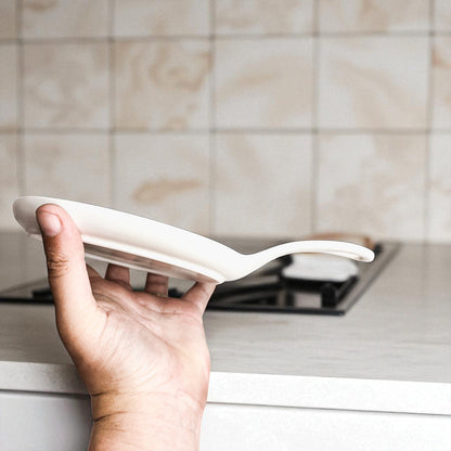 Love & Profanity spoon rest by Gia Roma, white ceramic curved design held in hand on Tampa Home & Garden Store