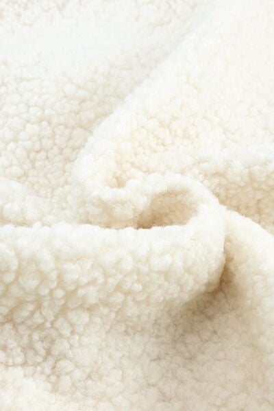 Women's sherpa jacket fabric close-up in cream, fluffy fleece texture on Tampa Home & Garden Store