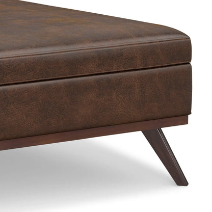 Owen square storage ottoman in brown leatherette with angled wood legs on Tampa Home & Garden Store