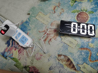 Stevvex acrylic mirror LED alarm clock with 4-digit display beside a white power strip on a rug on Tampa Home & Garden Store