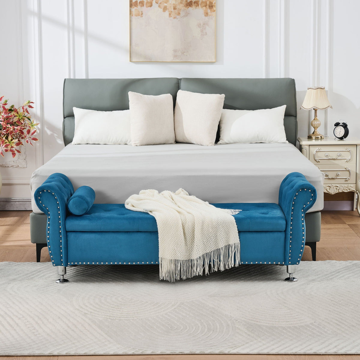 Storage bench with crystal button tufting in blue velvet, two blue bolsters and studded trim on Tampa Home & Garden Store