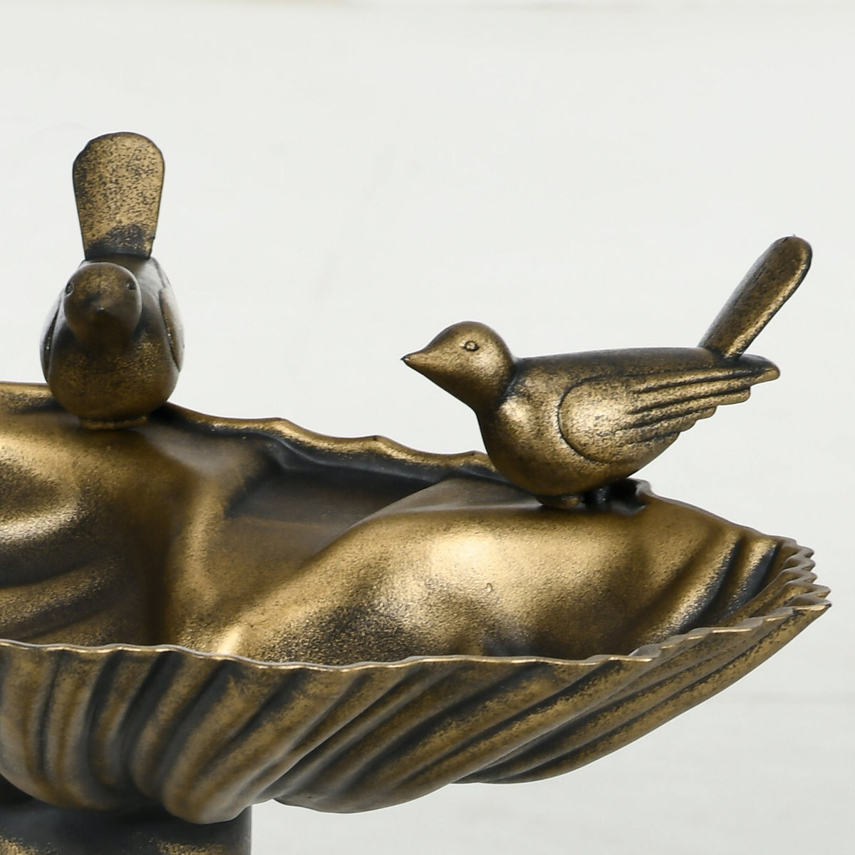 Antique bronze bird bath with perched birds on a decorative pedestal edge on Tampa Home & Garden Store
