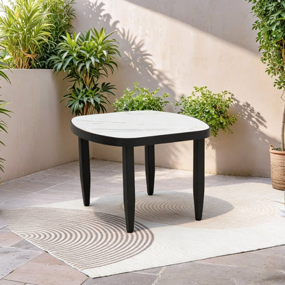Outdoor Elegance Table coffee table with rounded marble top and black legs in a sunlit courtyard on Tampa Home & Garden Store
