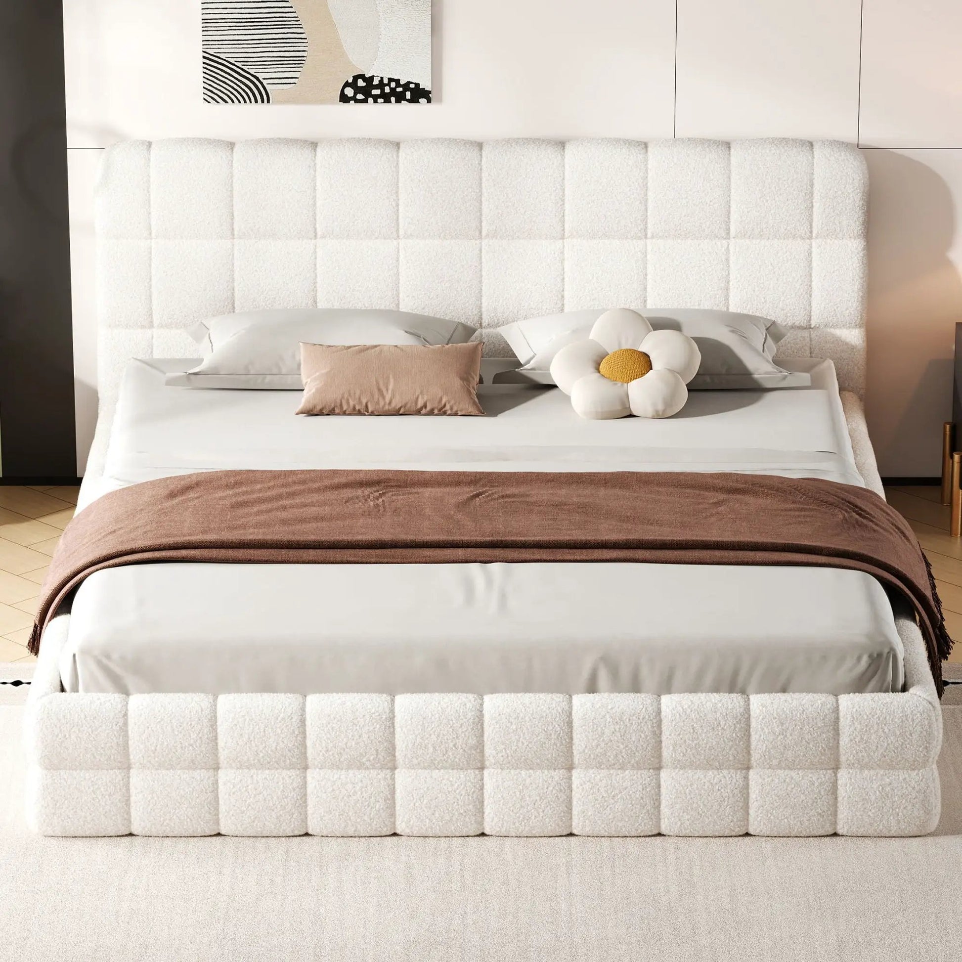 Upholstered platform bed with white tufted headboard, gray pillows, and a brown throw on Tampa Home & Garden Store