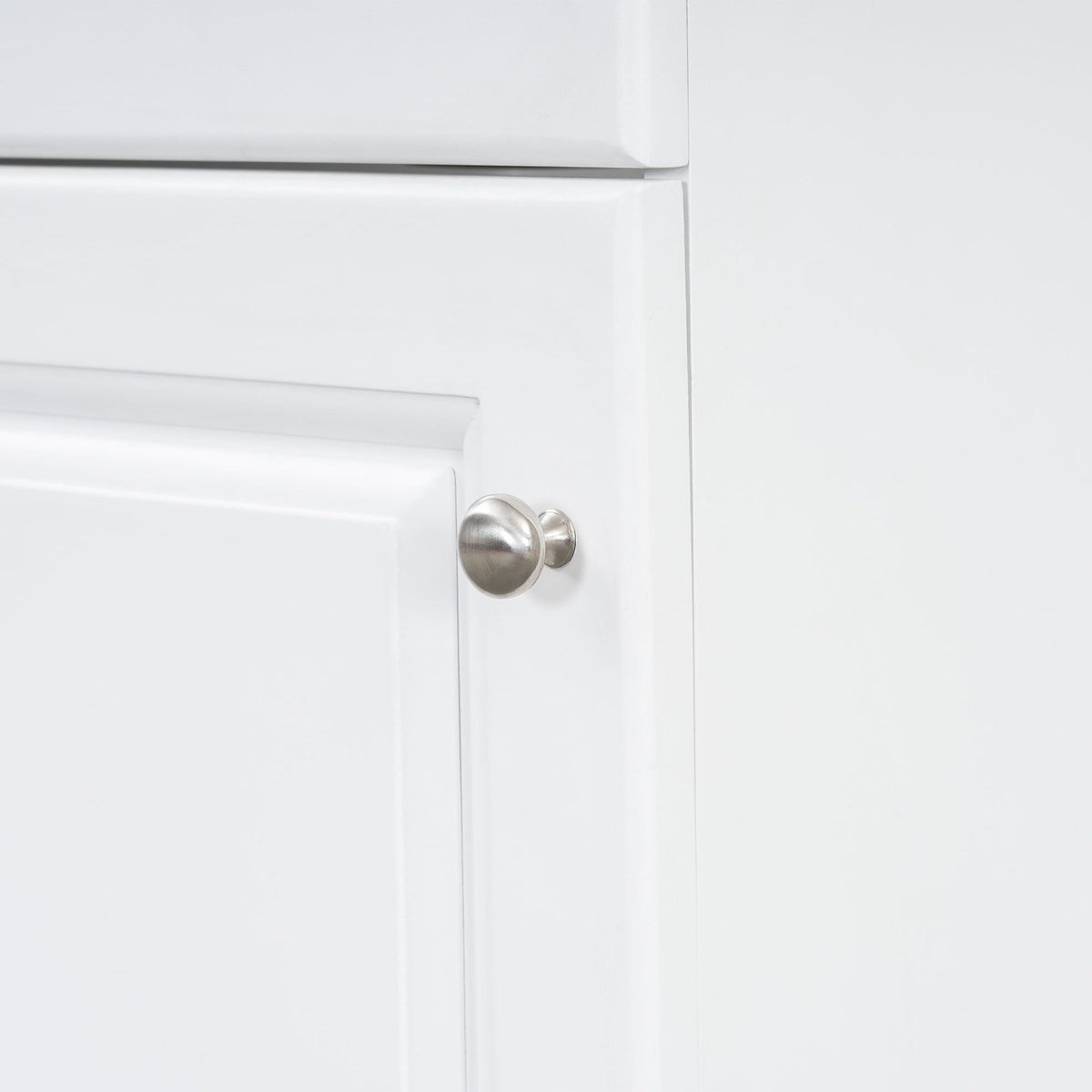 White bathroom vanity cabinet door with a brushed nickel round knob on Tampa Home & Garden Store