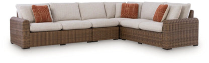 Dolan Creek Outdoor Sectional, brown wicker with beige cushions and orange pillows, stationary on Tampa Home & Garden Store