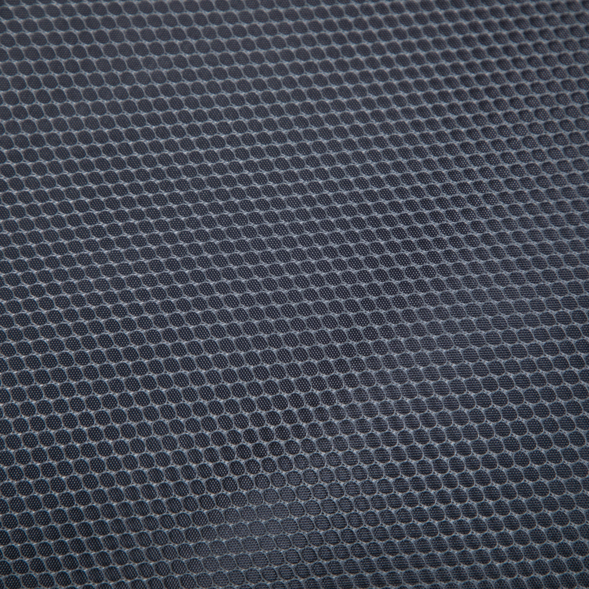 Luggage set fabric close-up in dark blue-gray with a circular dot texture on Tampa Home & Garden Store