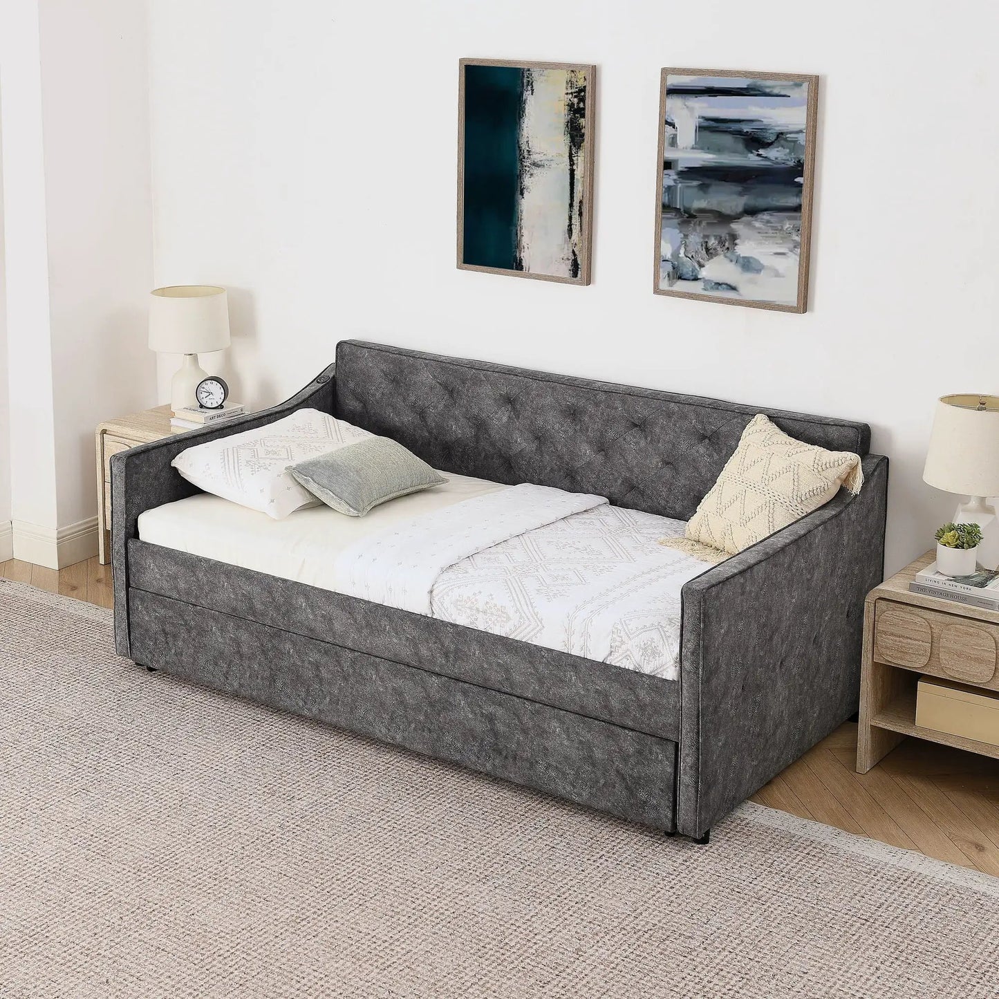 Daybed with pop up trundle and USB charging armrest in gray tufted fabric, white bedding on Tampa Home & Garden Store