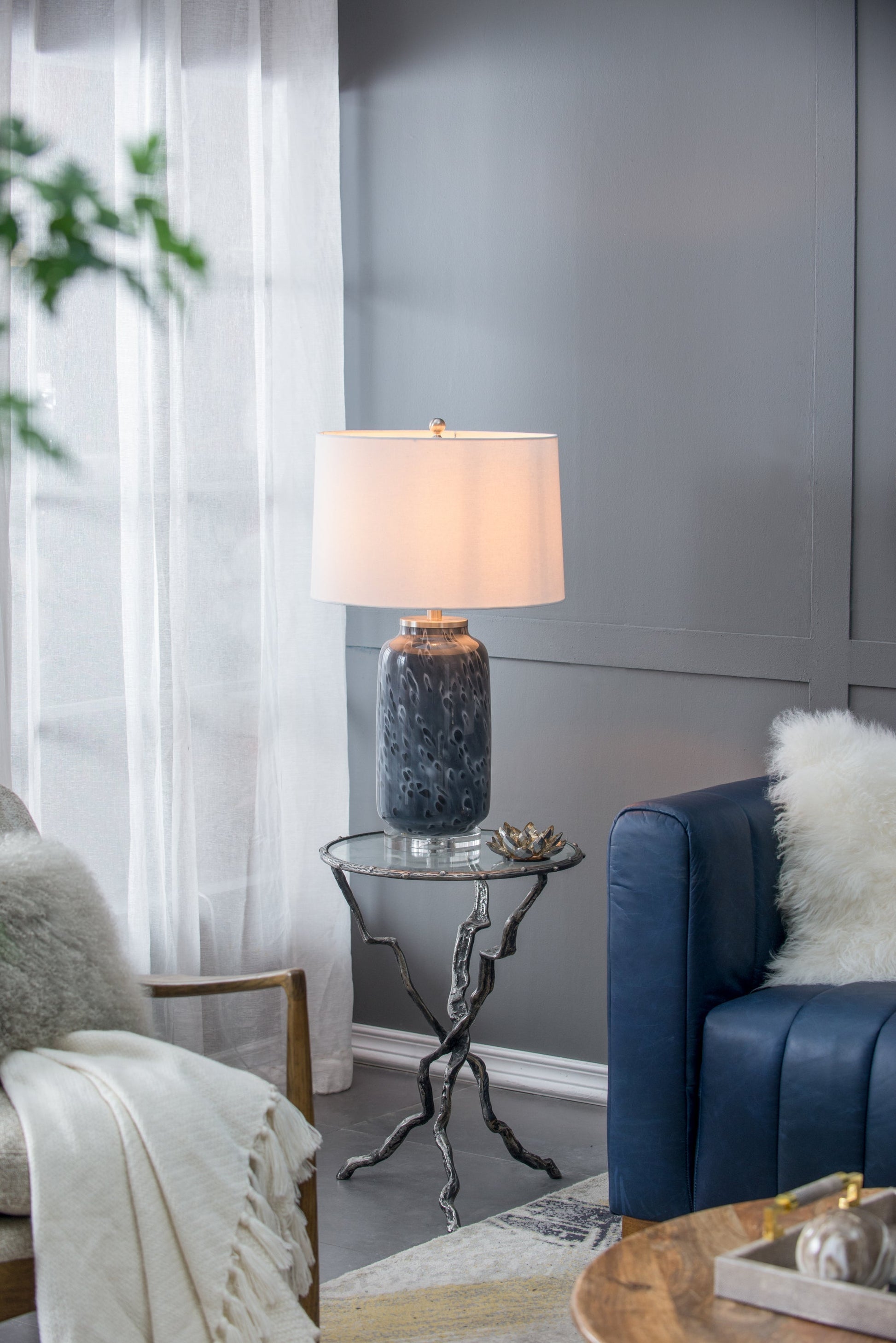 Ellis Glass Table Lamp by HouseOfZazla with a blue hammered glass base and beige drum shade on Tampa Home & Garden Store