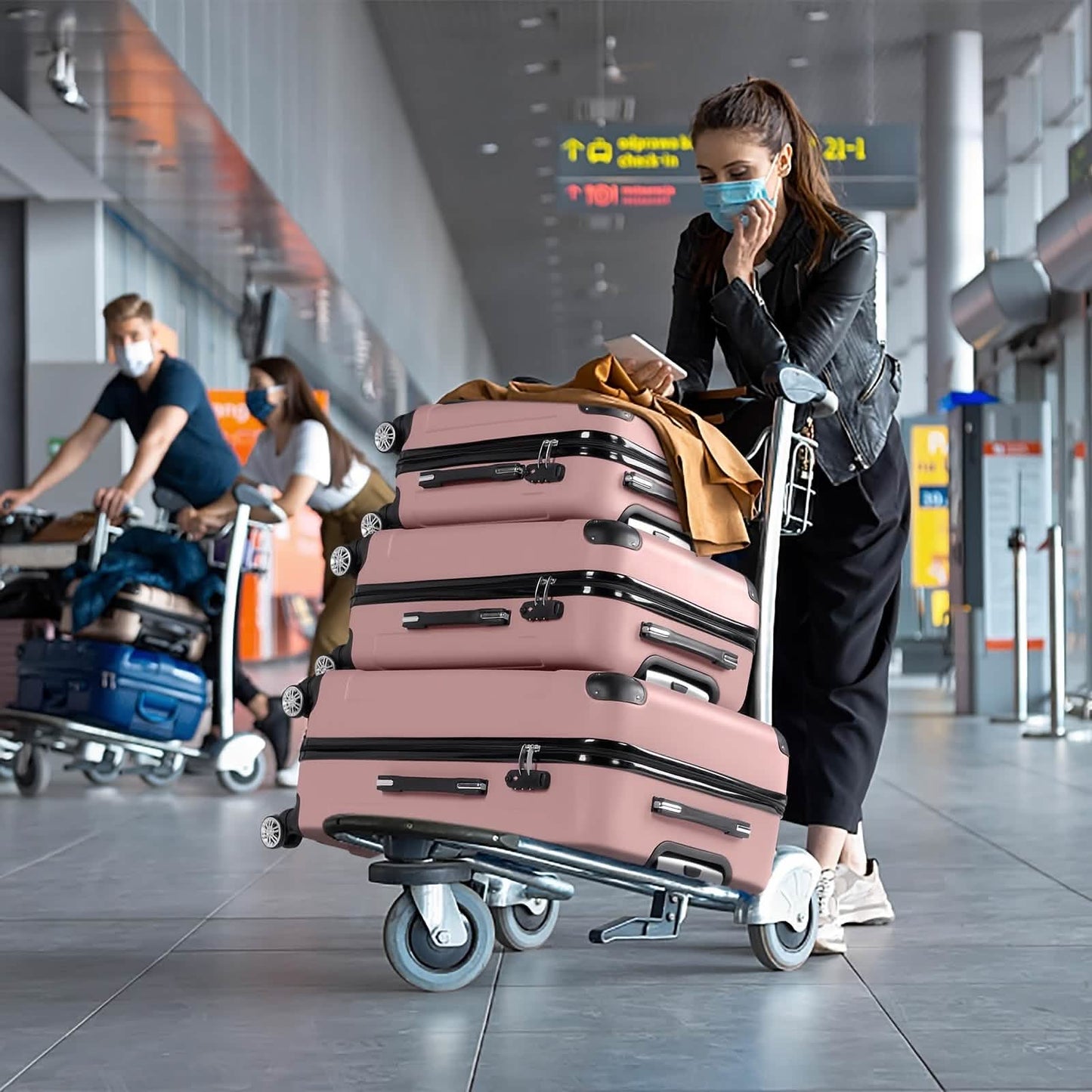 3-piece pink hard-shell luggage set with 360° spinner wheels on airport cart on Tampa Home & Garden Store